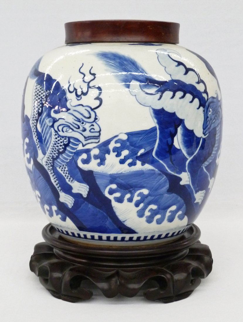 Antique Chinese Foo Lion Blue & White Porcelain Jar: Antique Chinese Foo Lion Blue & White Porcelain Jar with Wood Lid 8.75''x8''. Jar has four fierce looking blue underglaze foo dogs standing on fire or waves. Double ring mark underneath. Top rim has a