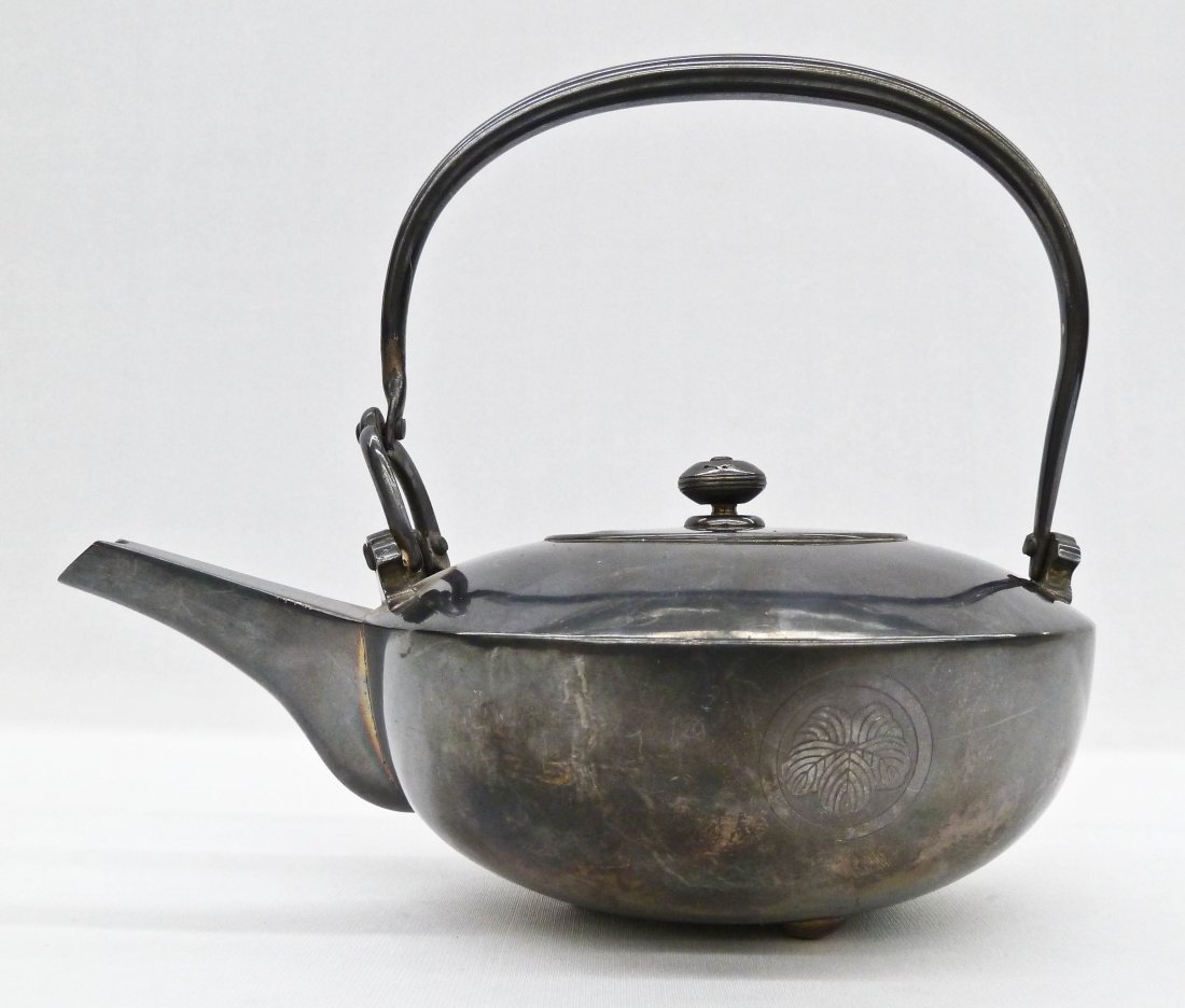 Meiji Japanese Fine Silver Chosi Sake Kettle or: Meiji Japanese Fine Silver Chosi Sake Kettle or Tetsubin Teapot 6.25''x7.25''. It has the two character Jungin sterling silver mark on bottom. Lid has a dent on side. Weighing 12.2 troy ounces.
