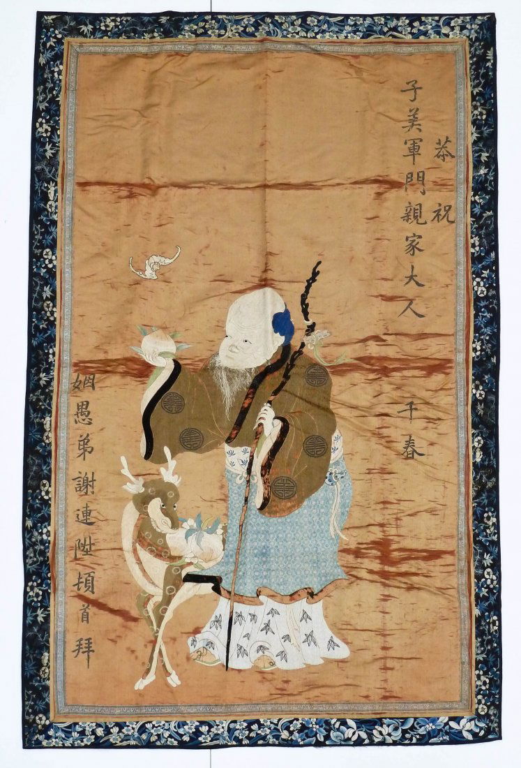 Antique Chinese Shou Xing with Deer Embroidered Silk: Antique Chinese Shou Xing with Deer Embroidered Silk Hanging Banner 68.5''x43''. Depicts god of longevity with two panels of embroidered calligraphy and a lone bat flying in the sky. Various fold tear