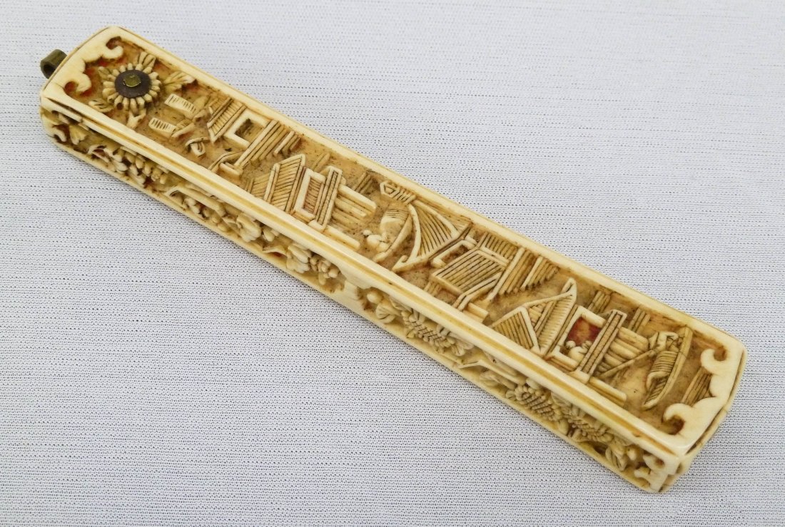 Chinese Ivory Fan Shaped Incense Box 4.25''x.75''.: Chinese Ivory Fan Shaped Incense Box 4.25''x.75''. Ornately carved with figures in boats amongst several temples on front, back, and sides. Some age cracking. Antique, Qing dynasty.