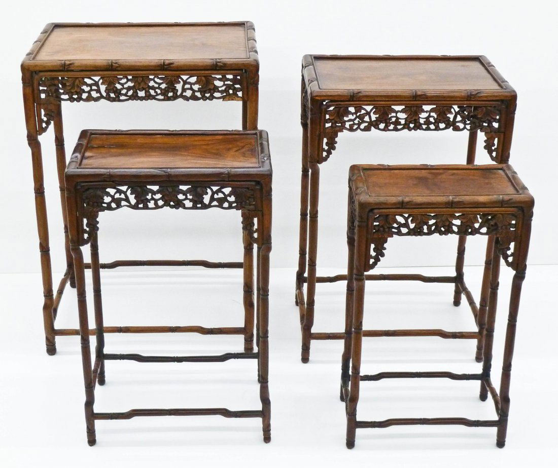 Set of (4) Chinese Carved Wood Nesting Tables. Largest: Set of (4) Chinese Carved Wood Nesting Tables. Largest measures 29''x20''x14'' and small is 22.5''x13''x7''. Each has a pierced carved edge depicting foliage with berries. Possibly huanghuali wood. So