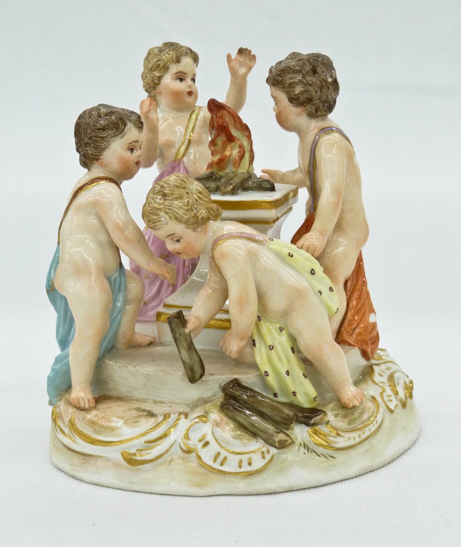 Meissen Porcelain Winter Figure Group with Putti Around: Meissen Porcelain Winter Figure Group with Putti Around a Fire 3.5''x3.25''. Depicts four putti around a fire burning on a pedestal. Old professional repair to one arm and small chip to drapery. Late 