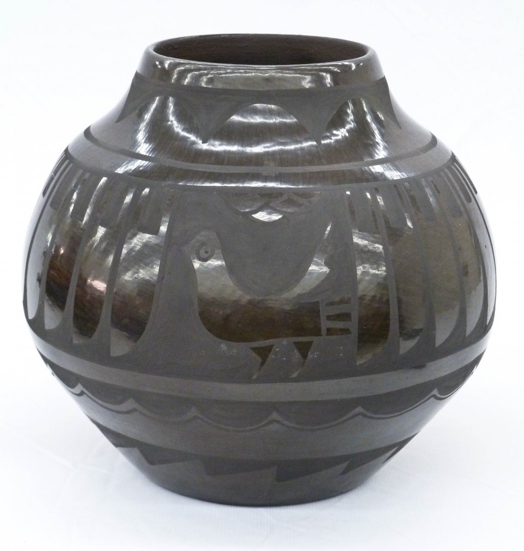 Carmelita Dunlap San Ildefonso Brown Olla 8''x9''.: Carmelita Dunlap San Ildefonso Brown Olla 8''x9''. Brown pueblo pot or vase depicting an etched repeating feather and bird design. Glaze miss 3'' on bird panel and 2'' hairline crack emanating from to