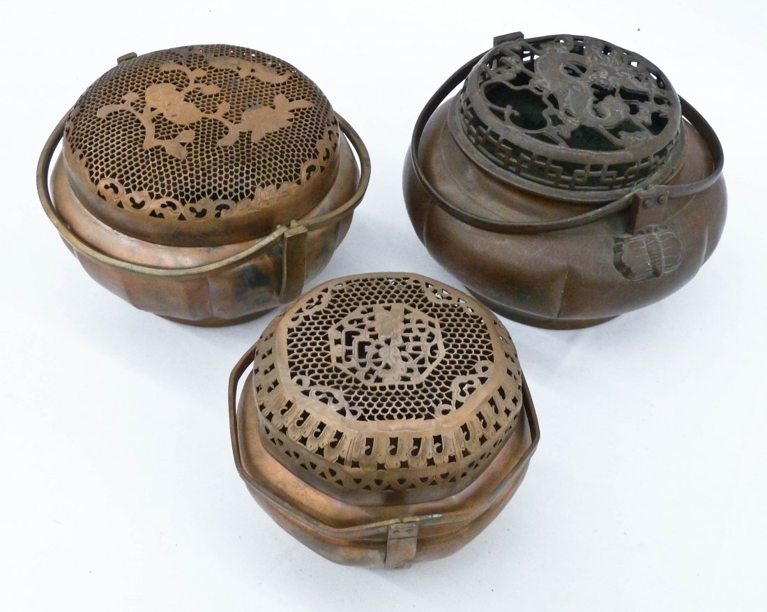 (3) Old Chinese Metal Hand Warmers. They vary in size: (3) Old Chinese Metal Hand Warmers. They vary in size from 4''x5.5'' to 4.5''x7''. Each has a pierced top with dragon and floral designs. Dragon box bears an impressed Xuande six character mark on bot