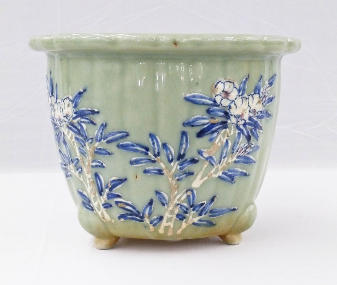Antique Chinese Celadon Ground Porcelain Jardinier: Antique Chinese Celadon Ground Porcelain Jardinier 8''x10.5''. Raised floral motifs with blue and white underglaze decoration. Tripod lobed form planter. Late Qing dynasty.
