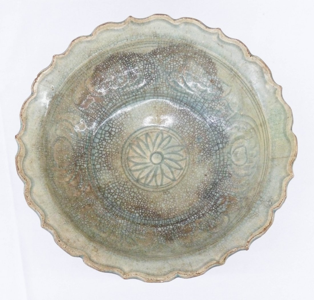 Antique Thai Sawankhalok Celadon Glazed Stoneware Large: Antique Thai Sawankhalok Celadon Glazed Stoneware Large Bowl 4''x12.5''. Carved stylized floral motif in center. Glaze crazing and two cracks to bowl. 14th/15th century.