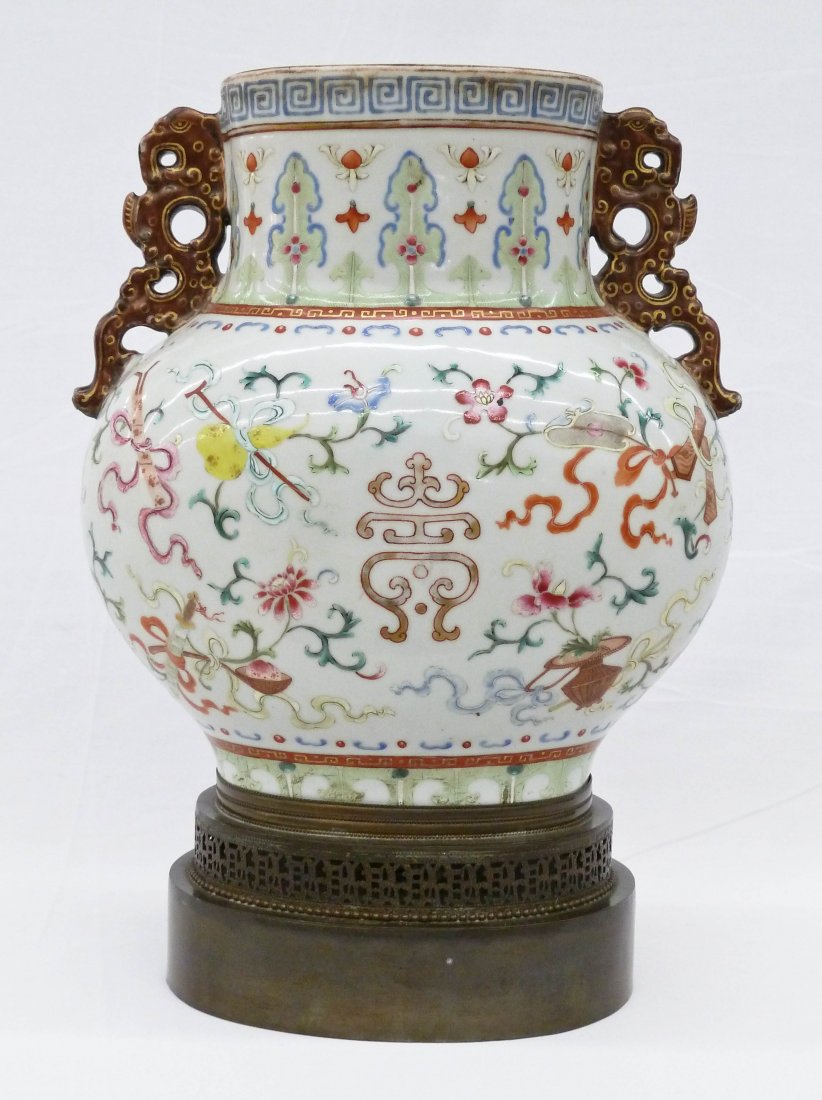 Important Chinese Famille Rose Porcelain Handled Vase: Important Chinese Famille Rose Porcelain Handled Vase 10''x9''x5.5''. This period handled vase has gilt and polychrome enameling of the eight Buddhist precious symbols. It was once a covered urn, but 