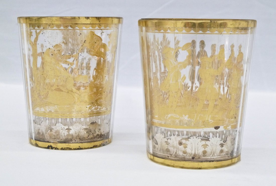 Pair Bohemian Zwischengold Gilt Glass Beaker Cups: Pair Bohemian Zwischengold Gilt Glass Beaker Cups 3.25''x2.75'' Each. Faceted cut with silver and gold gilt decoration. Both depict battle scenes. One small chip to bottom edge of one and bottom plate