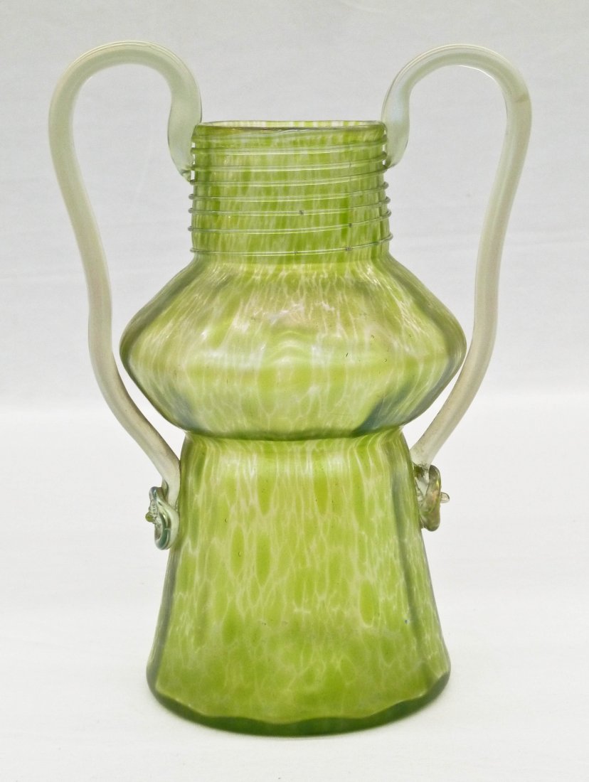 Loetz Green Handled Art Glass Vase 8.75''x6.25''.: Loetz Green Handled Art Glass Vase 8.75''x6.25''. Applied threading on top with impressed rosettes and end of handles. Similar to their Creta Papillon line.