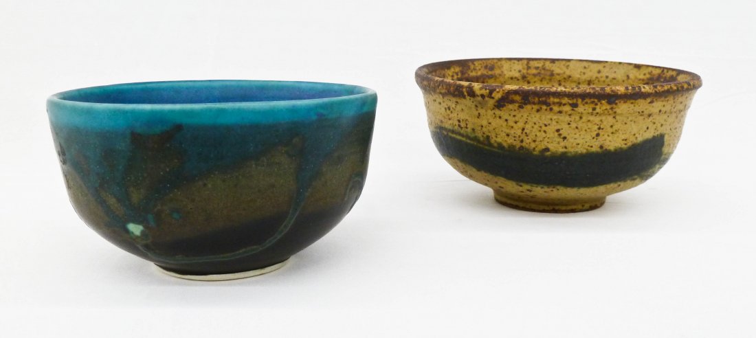 Toshiko Takaezu (1922-2011 New Jersey) Two Studio: Toshiko Takaezu (1922-2011 New Jersey) Two Studio Pottery Tea Bowls. Includes a speckled mustard yellow glaze bowl 2.5''x5.25'' and a stark turquoise and black glazed bowl 2.5''x4.75''. Well known Jap