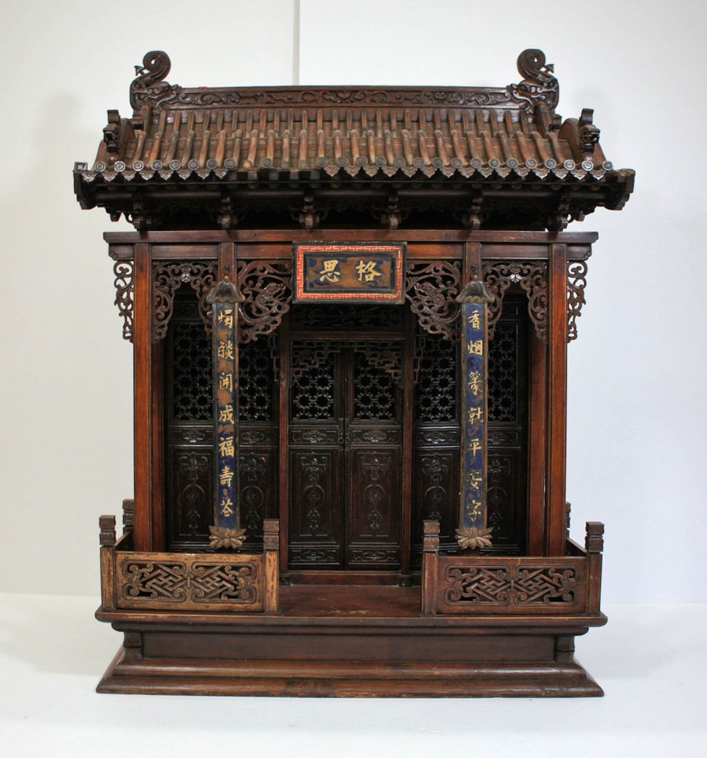Antique Chinese Buddhist Carved Wood Shrine: Antique Chinese Buddhist Carved Wood Shrine 45.5''x20''x33''. Intricately pierced carved doors with bat and coin symbols. Figural dragon heads on edges of roof. Qing dynasty.