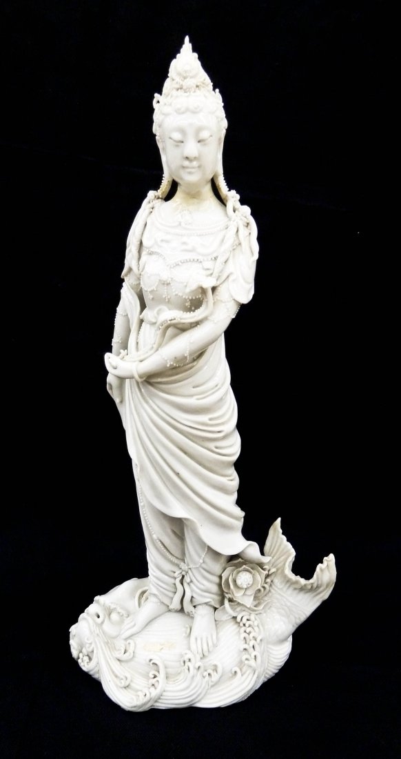 Antique Chinese Blanc de Chine Guanyin Porcelain Figure: Antique Chinese Blanc de Chine Guanyin Porcelain Figure 16.5''x7.75''. Fine porcelain figure holding a ruyi scepter and standing on a lion fish. Old repair at neck and braids. Bears an impressed four 