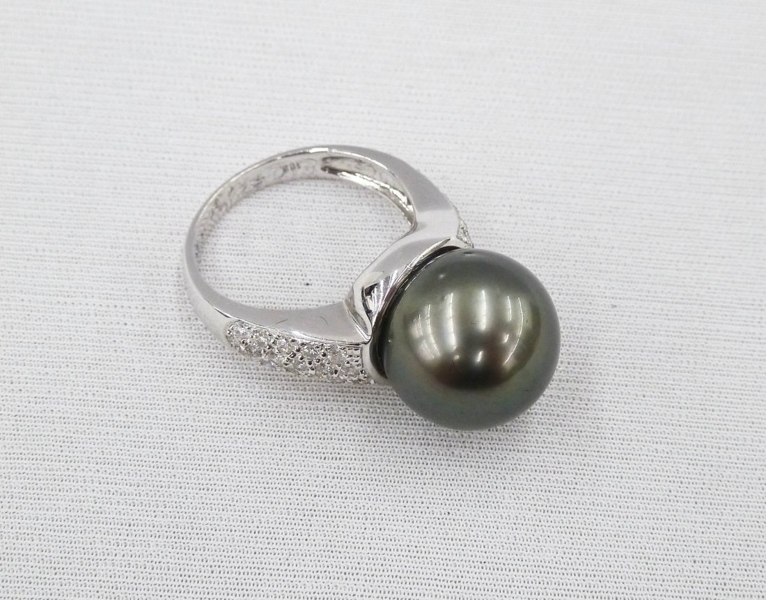 Lady's 18k Black Pearl & Diamond Ring. Includes one: Lady's 18k Black Pearl & Diamond Ring. Includes one 13mm cultured Tahitian pearl with approximately 1.13ctw of diamonds. Size 7.