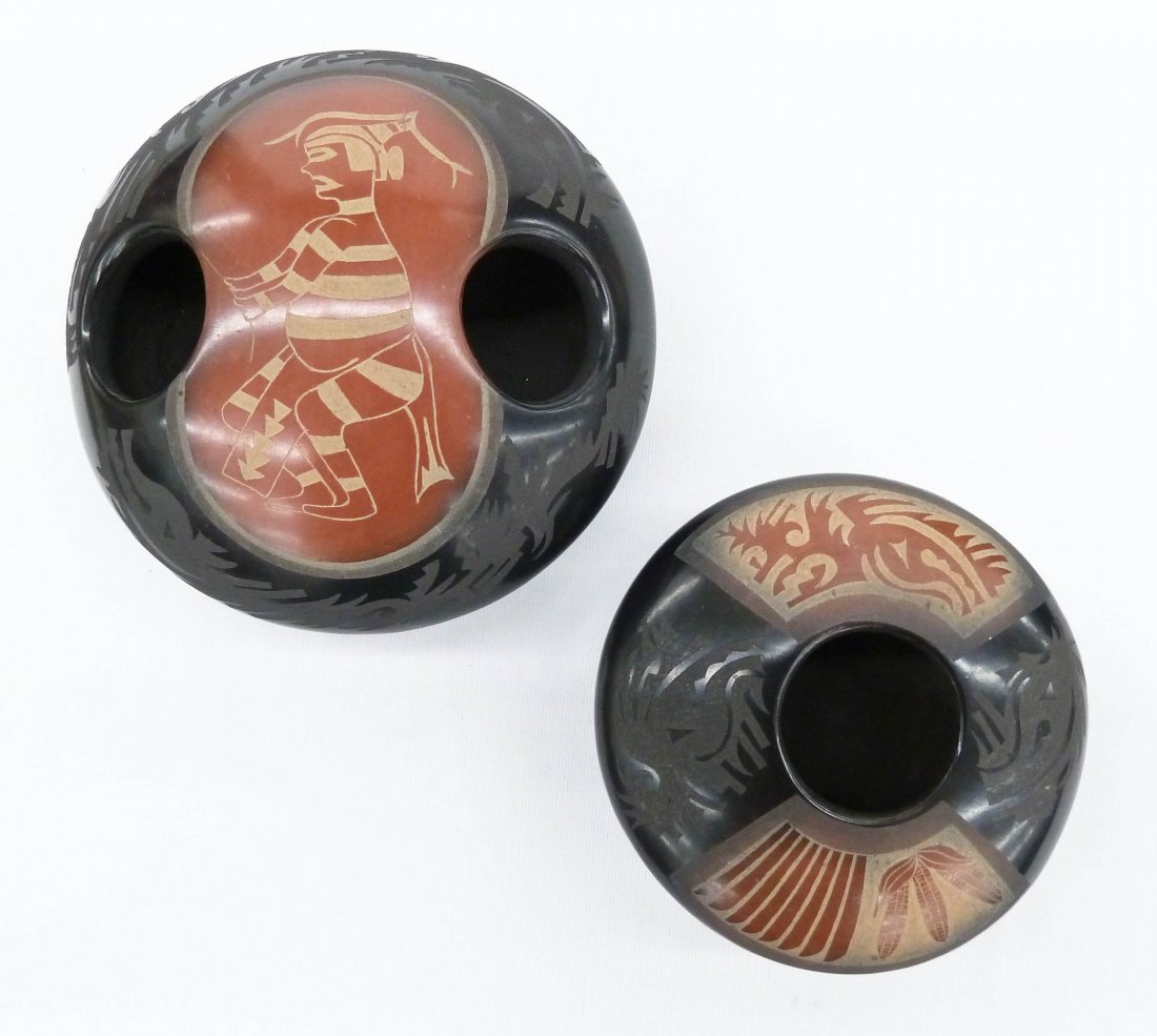 2pc Grace Medicine Flower (b.1938 Santa Clara): 2pc Grace Medicine Flower (b.1938 Santa Clara) Blackware Pottery Seed Pots. First is a double holed pot 2.5''x4.5'' with sgraffito Hano Clown Kachina. Second has water serpent and corn/feather design 