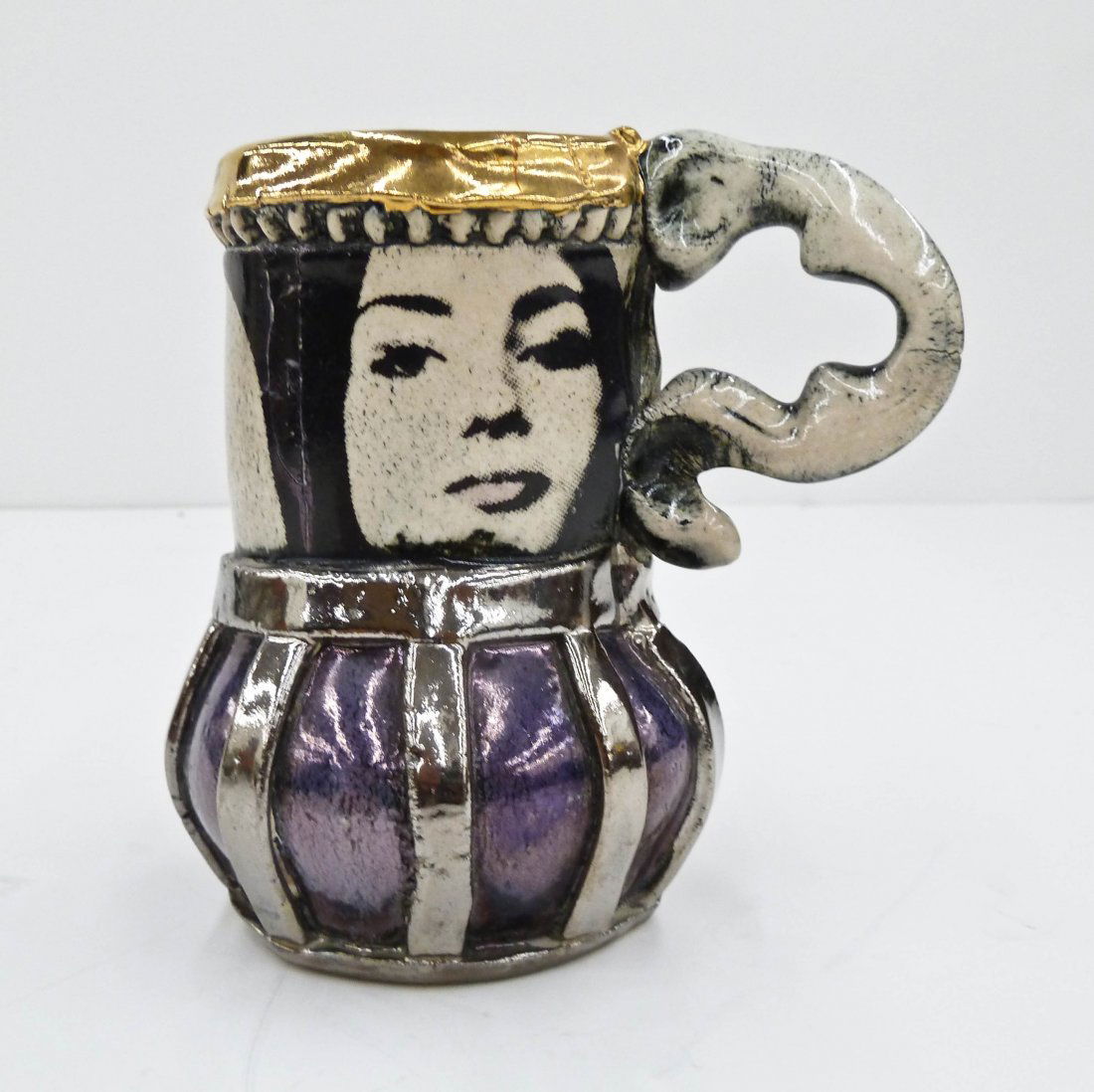 Erik Gronborg (b.1931 California) Ceramic Mug 5''x5''.: Erik Gronborg (b.1931 California) Ceramic Mug 5''x5''. Silver and gold luster glazes with woman nude decals. Impressed signature on side. Excellent condition.
