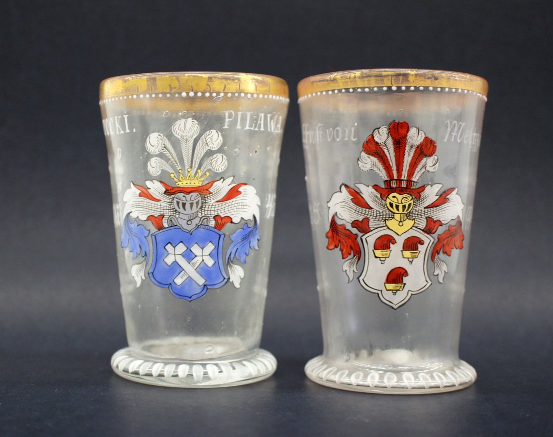 Two antique German blown glass beakers. Dated 1594 and: Two antique German blown glass beakers. Dated 1594 and 1643. Both measure 4.75'' tall. Coat of arms motif. Excellent condition.