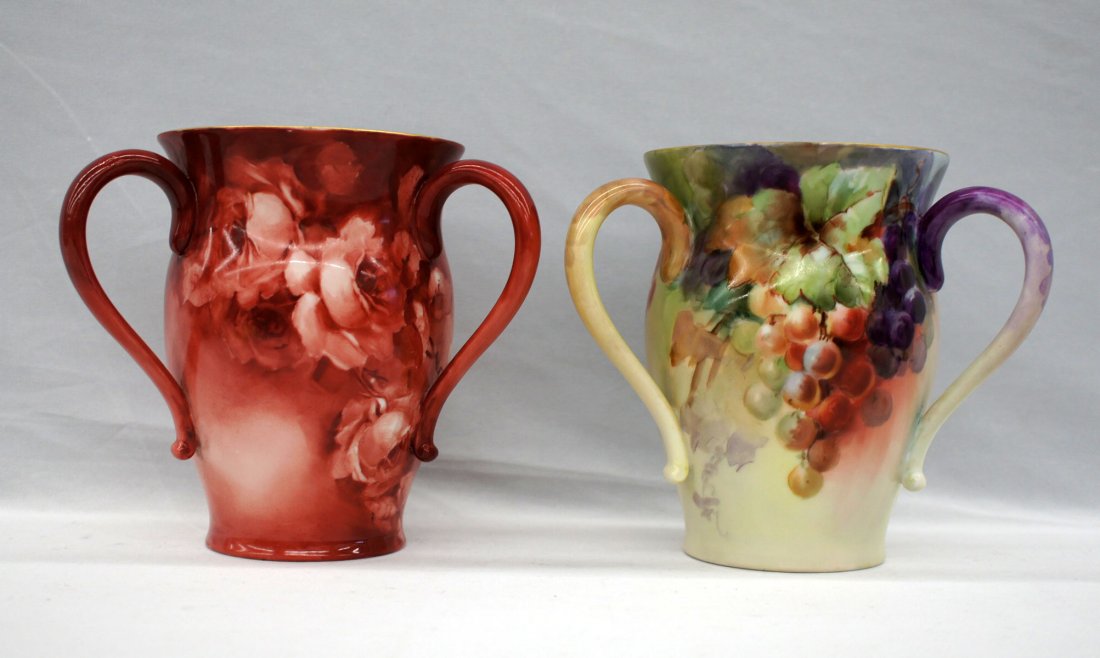 Two Jean Pouyat Limoges floral loving cup vases. Both: Two Jean Pouyat Limoges floral loving cup vases. Both measure 6.25'' tall and are in excellent condition.