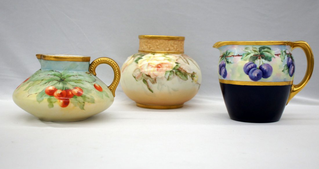 Three Jean Pouyat Limoges floral hand painted pitchers: Three Jean Pouyat Limoges floral hand painted pitchers and vase. This group includes 5'' x 7.75'' squat pitcher, 6'' x 7.75'' grape design pitcher and 6.5'' x 7'' vase. No damage.