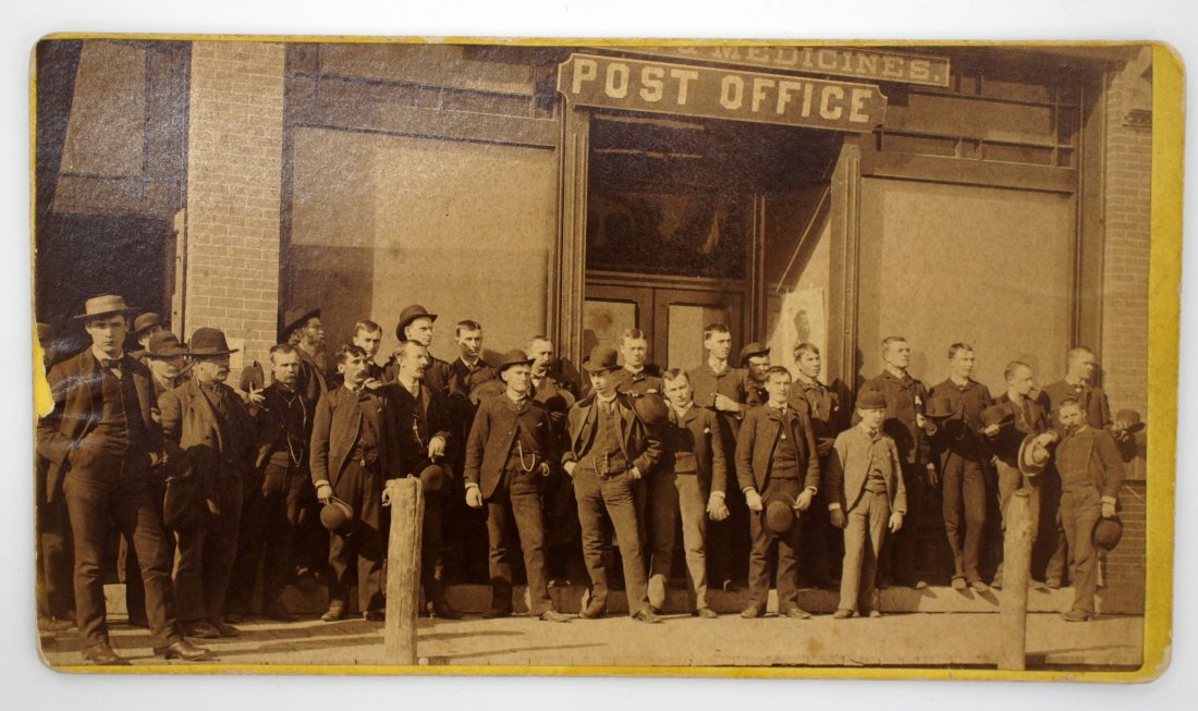 Albumen street scene photo with Post Office in: Albumen street scene photo with Post Office in background. by Casselton, D.T. 4'' x 7'', yellow mount, good condition.