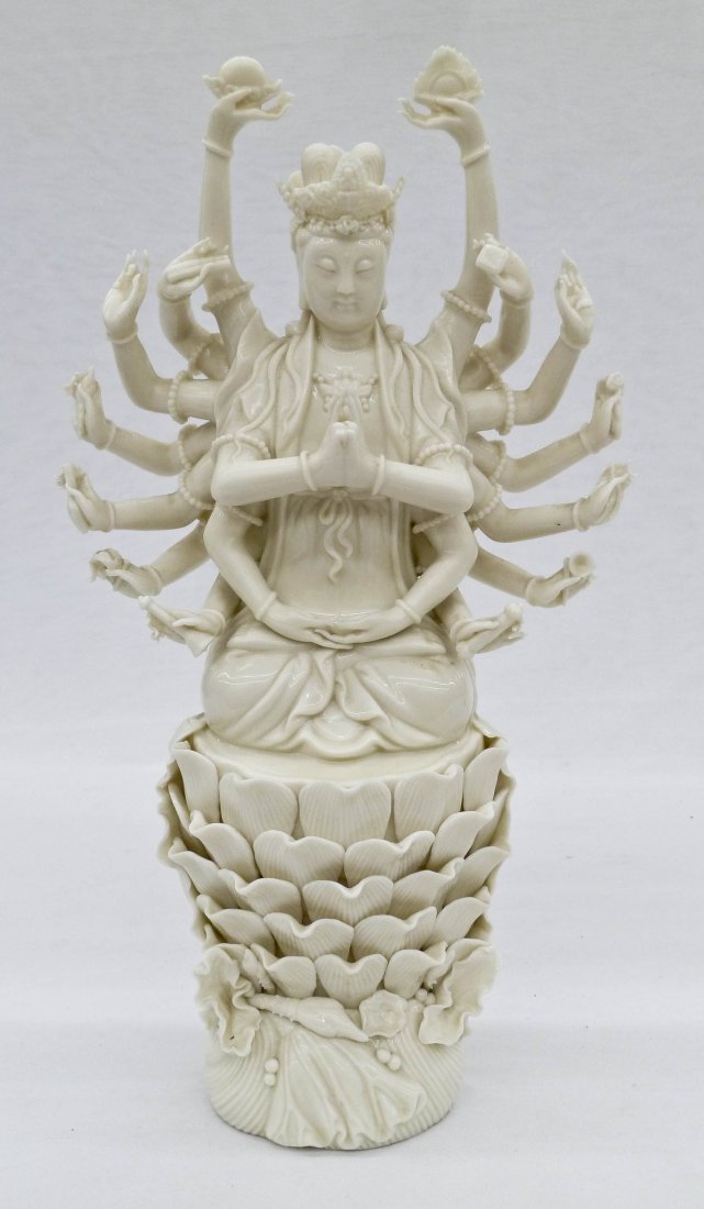 Fine Chinese Blanc de Chine Thousand Arm Guanyin: Fine Chinese Blanc de Chine Thousand Arm Guanyin Porcelain Figure 13.25''x7.25''. Holding various symbols of the buddha on lotus throne. One tiny chip to edge of finger. 20th century.