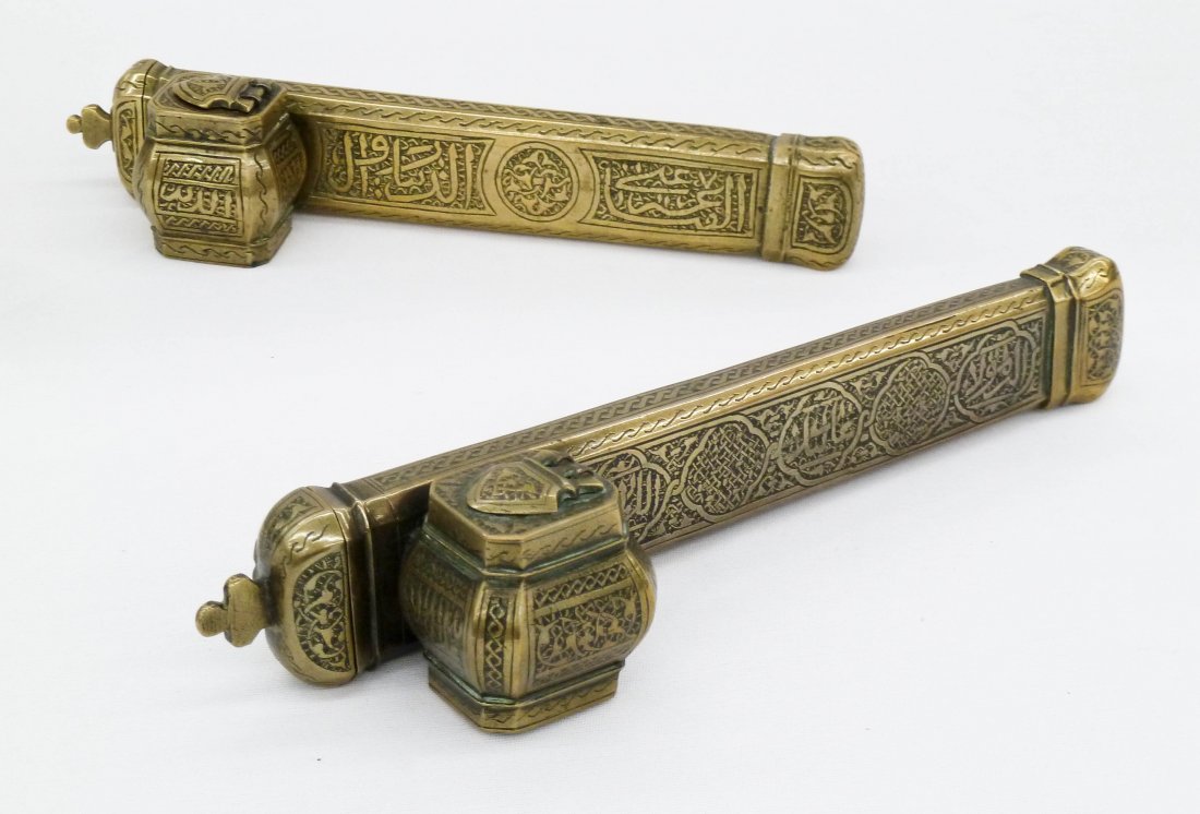 2pc Antique Islamic Brass Traveling Scribe's Quil Pen: 2pc Antique Islamic Brass Traveling Scribe's Quil Pen Cases. They measure 9.25''x2.25'' and 8.5''x2.25''. Etching with arabic calligraphy on sides. 19th century.