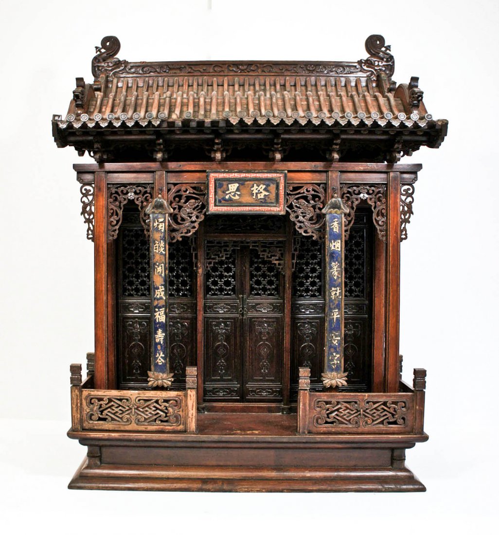 Antique Chinese Dragon Carved Wood Buddhist Shrine: Antique Chinese Dragon Carved Wood Buddhist Shrine 45.5''x20''x33''. Intricately pierced carved doors with bat and coin symbols. Figural dragon heads on edges of roof. Qing dynasty. Some scattered sma