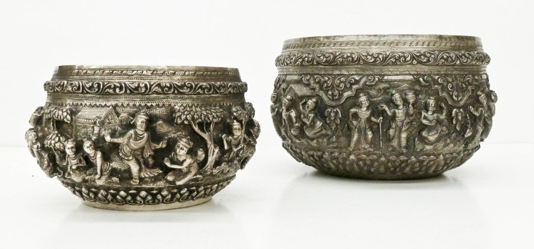 2pc Antique Thai Repousse Silver Bowls. Each depicts: 2pc Antique Thai Repousse Silver Bowls. Each depicts various figures in deep relief with animals and foliage. Large bowl measures 4.5''x7.5'' and smaller is 3.25''x5.5''. Some slight dents. Both weigh