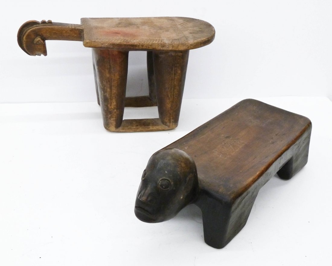 2pc Dogon West Africa Carved Wood Stools. First stool: 2pc Dogon West Africa Carved Wood Stools. First stool has a stylized angular head 14''x7.5'' and second has a more naturalistic male head 15''x6.25''. Overall edge wear to African works.