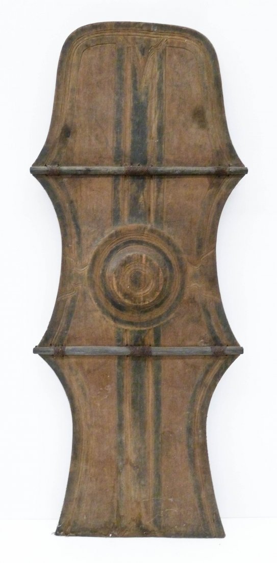 Old Mindanao Native Tall Wood Shield 45''x18''. Relief: Old Mindanao Native Tall Wood Shield 45''x18''. Bagobo war shield with relief carved motifs. Some edge chipping and wear from use. Philippines native weapons.