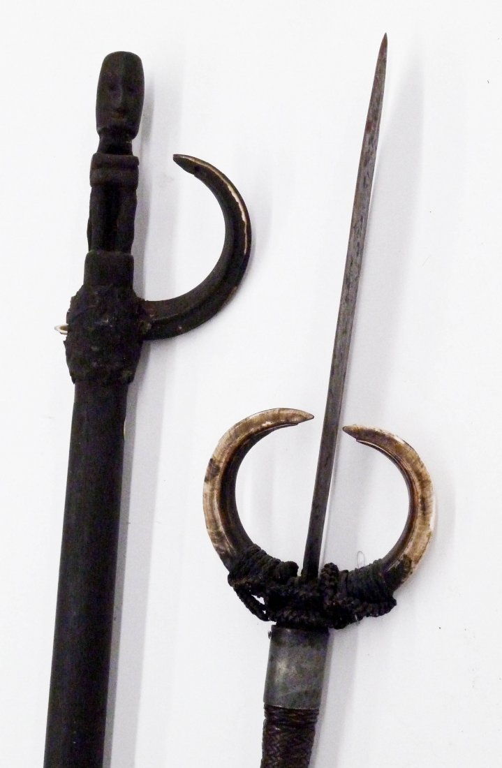 2pc Mindanao Native Spears with Boar Teeth. Sizes are: 2pc Mindanao Native Spears with Boar Teeth. Sizes are 50'' and 76'' in length. One is missing a tooth on side. Philippines native weaponry.