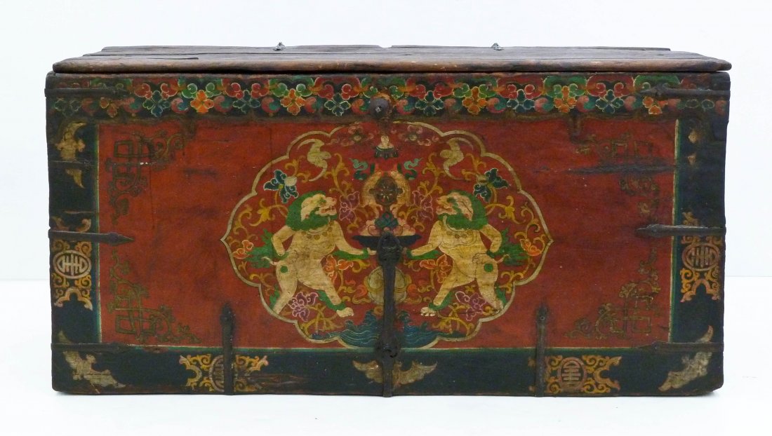 Antique Tibetan Polychrome Wood Trunk or Chest: Antique Tibetan Polychrome Wood Trunk or Chest 43''x22''x16''. Depicts opposing foo lions with scrolling foliage on front panel. Cracking and edge chipping consistent with age.