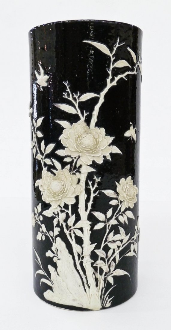 Antique Chinese Relief Molded Porcelain Cylinder Vase: Antique Chinese Relief Molded Porcelain Cylinder Vase 11.5''x5''. Blossoming chrysanthemum flowers with bird and butterfly in relief. Stark black glazed ground. Carved seal mark on bottom, obscured. D