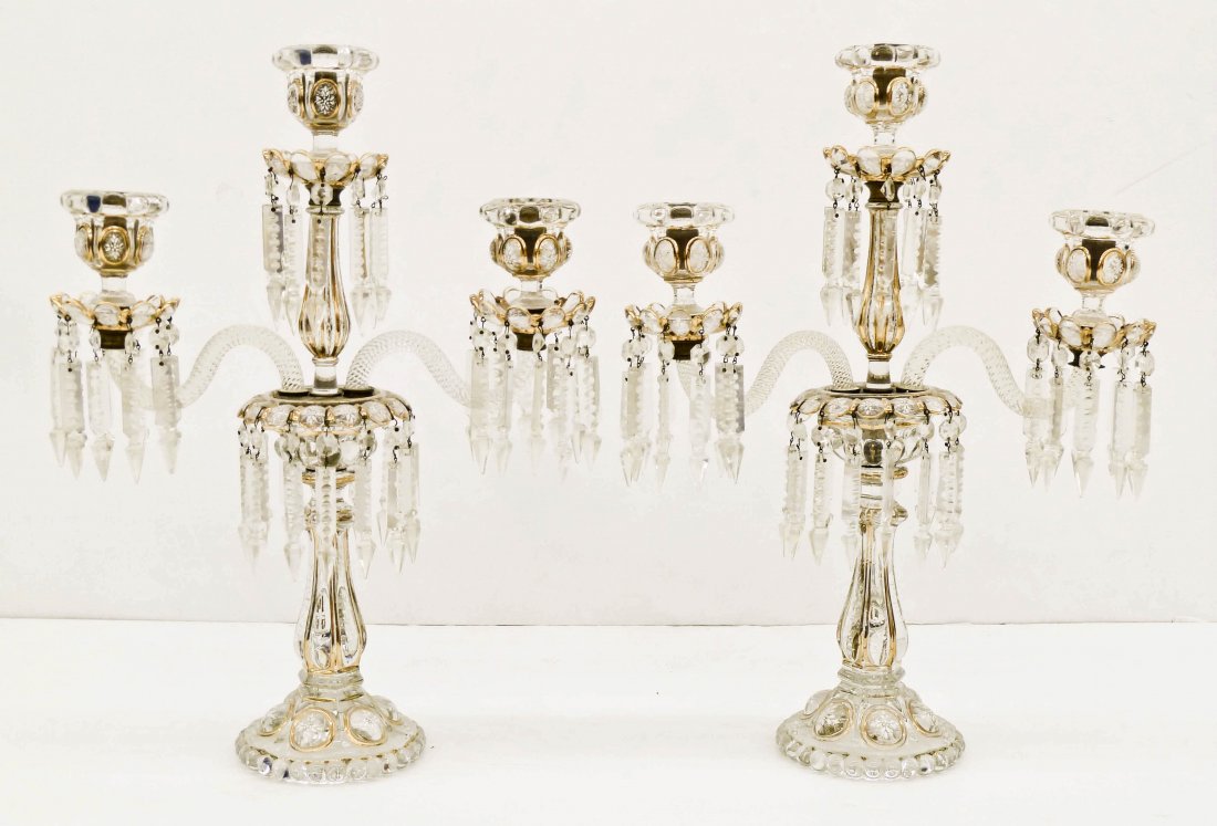 Pair Baccarat French Enameled Crystal Candelabras: Pair Baccarat French Enameled Crystal Candelabras 21''x15.5''. Molded glass bodies with white floral enameled oval ''Medallion'' panels. Complete with cut spear prisms. Chip to stem of one cup. Cups h