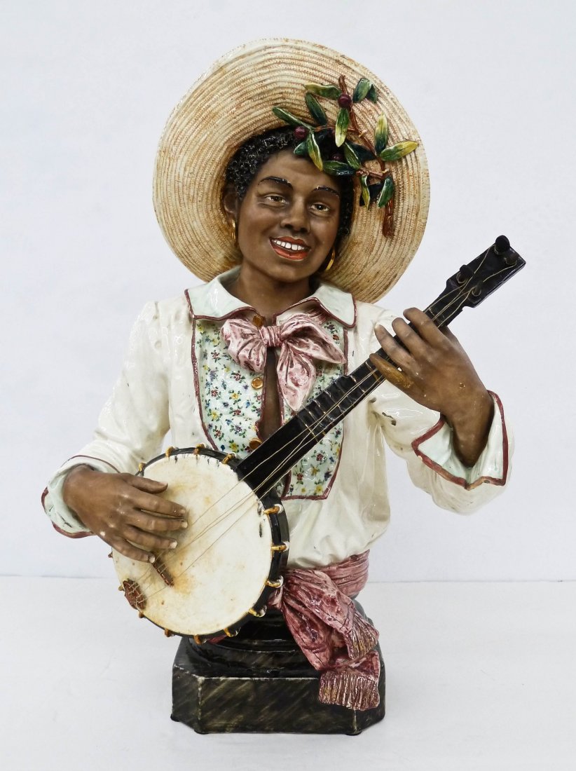 Antique Austrian Majolica Blackamoor Banjo Player Bust: Antique Austrian Majolica Blackamoor Banjo Player Bust 26''x18.5''x11''. Polychrome faience glazes with detailed features. One finger and head of banjo have old professional repairs. Edge chipping to