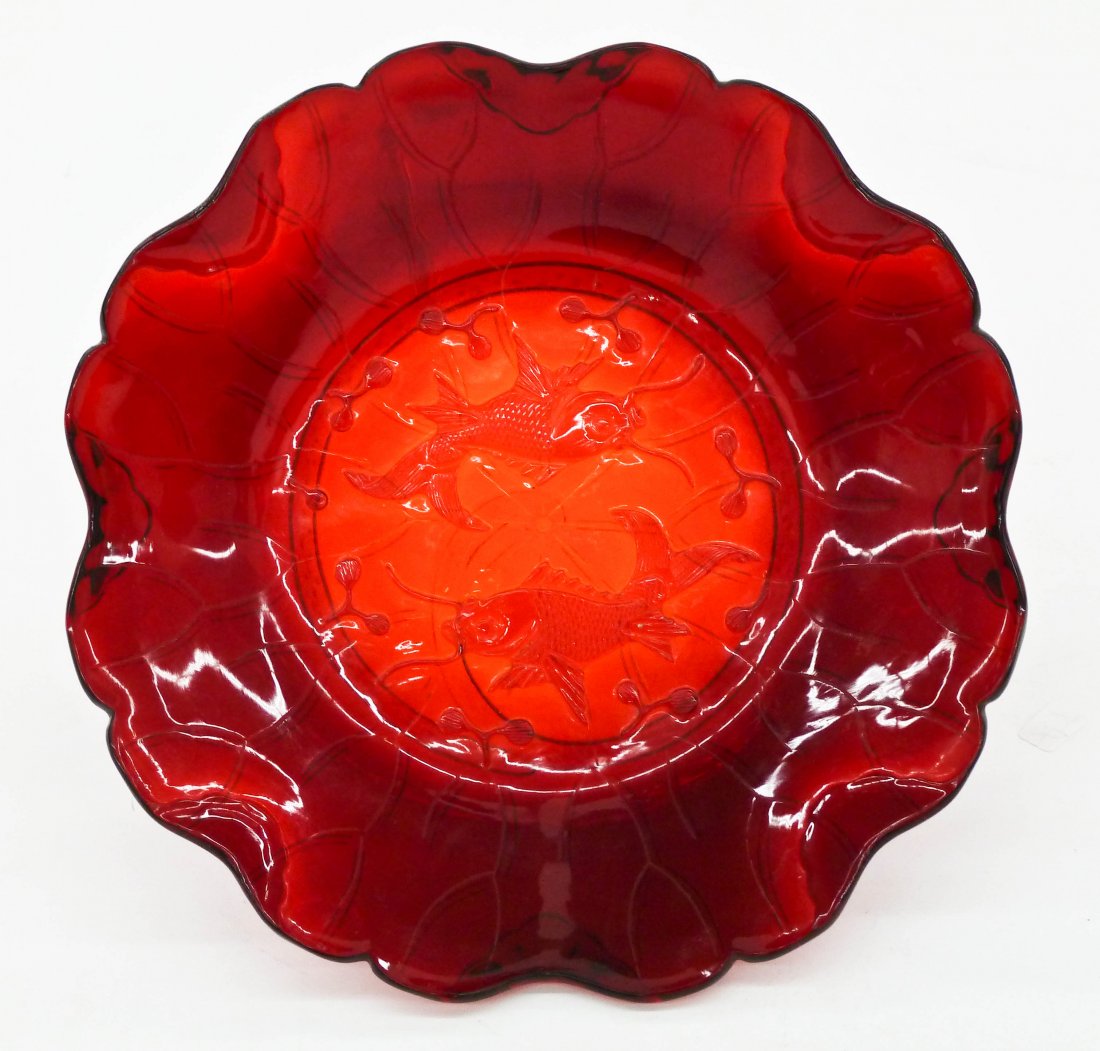 A Fine Chinese Red Peking Glass Lotus Bowl: A Fine Chinese Red Peking Glass Lotus Bowl 1.25''x6.5''. Intricately carved twin fish motif on figural lotus leaf form. Stark translucent red glass. It comes with carved rosewood stand and fitted silk