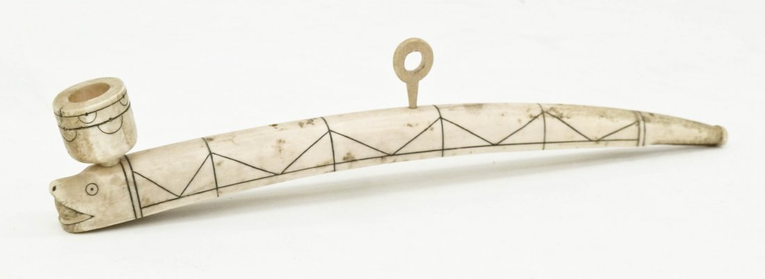 Antique Eskimo Scrimshawed Ivory Pipe 12.5''x2.5''.: Antique Eskimo Scrimshawed Ivory Pipe 12.5''x2.5''. Figural seal head end with goemetric scrimshaw designs. Late 19th or early 20th century, Inuit Yupik or Inupiaq Alaskan.
