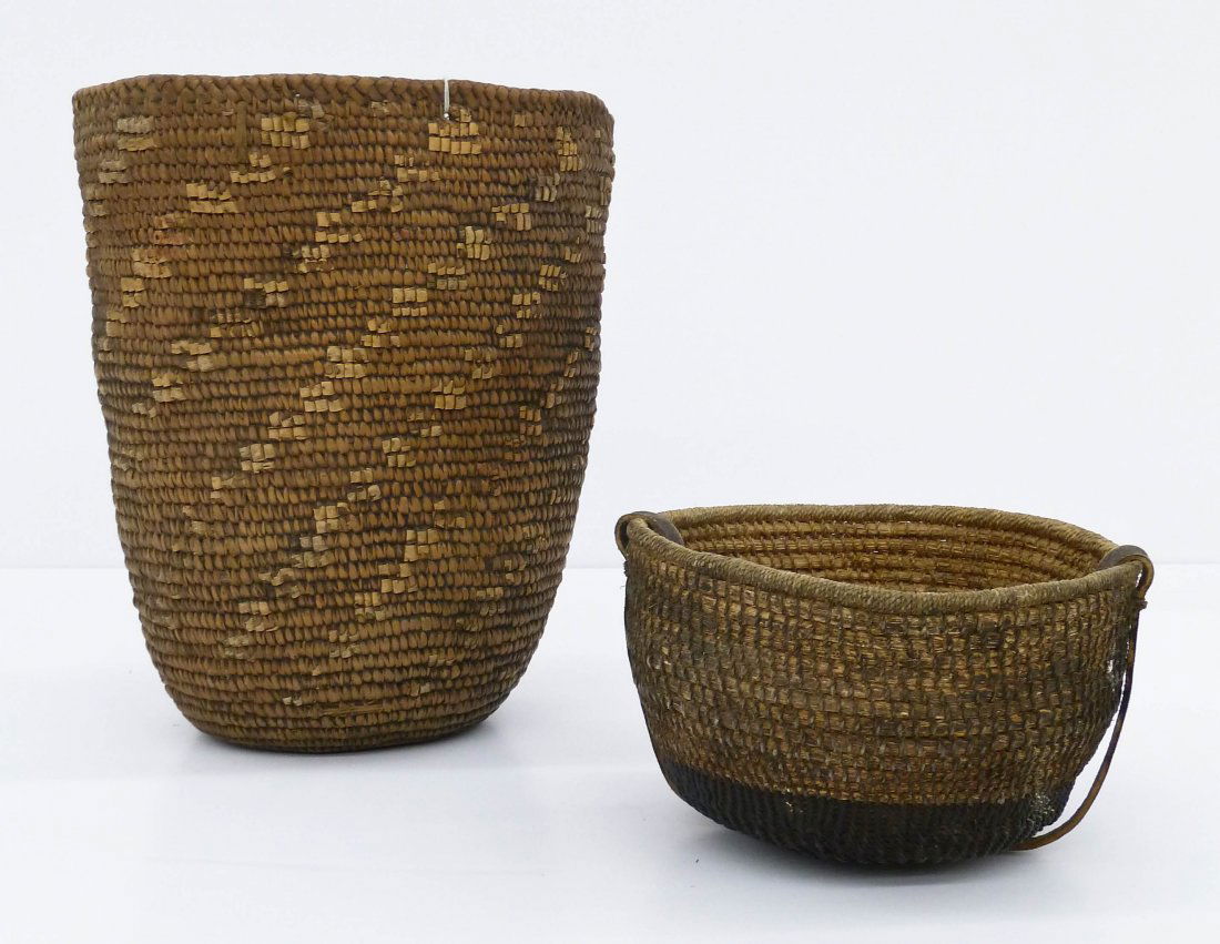2pc Antique Indian Baskets. Includes a klickitat hard b: 2pc Antique Indian Baskets. Includes a klickitat hard basket 11"x9.5" and an unidentified wood/metal coiled basket with leather strap 4.5"x7.5". Both baskets have wear and staining from use. Late 19th