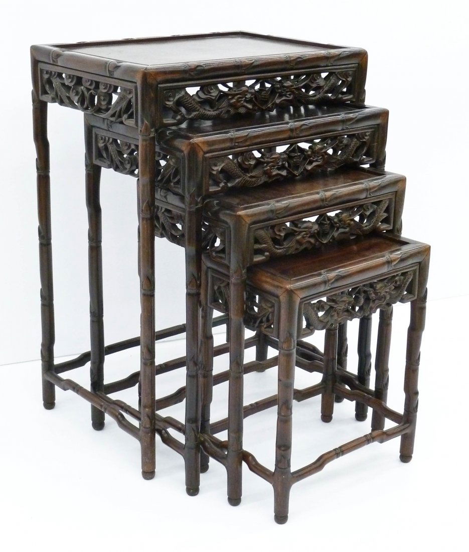 A Set of Chinese Rosewood Nesting Tables: A Set of Chinese Rosewood Nesting Tables 28''x19.5''x14''. Matching graduated four pieces set. Each has pierced carved opposing dragons chasing the flaming pearl. Overall excellent condition. 19th cen