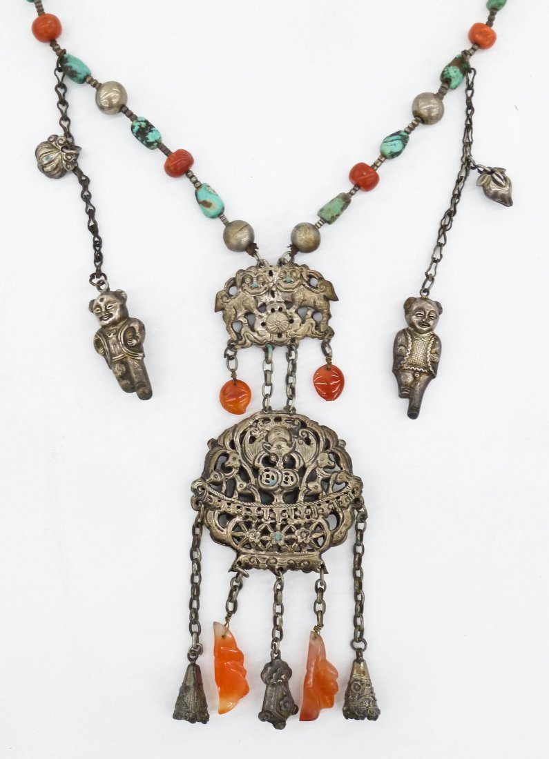 Antique Chinese Silver Toggle Necklace. It has a: Antique Chinese Silver Toggle Necklace. It has a pierced silver censer with bat pendant and twin foo lions. Beads are natural carved red coral, turquoise, and carnelian agate. The pendant measures 6''
