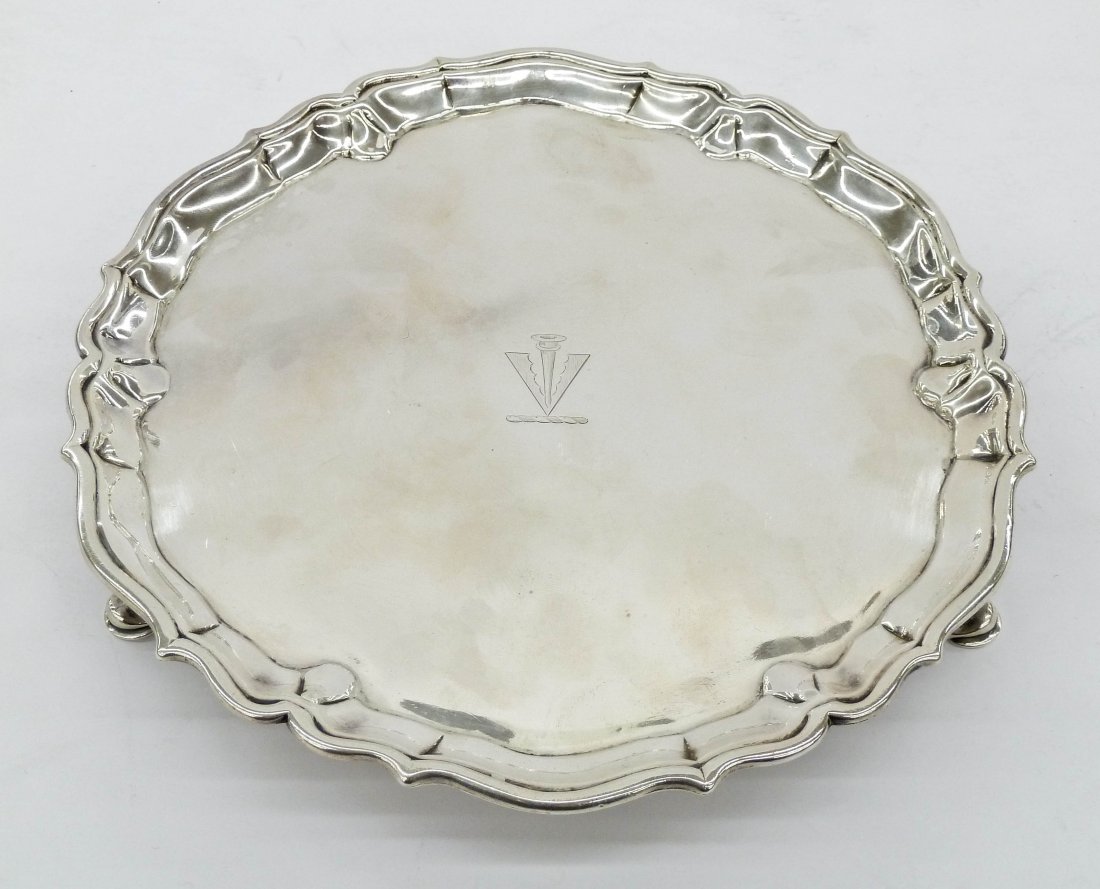 George III Silver Salver by Robert Abercrombie, London: George III Silver Salver by Robert Abercrombie, London 8.5''x1''. English hallmarked sterling tray date marked 1778. It has a stylized crest engraved into center. Marks are slightly worn, but readable