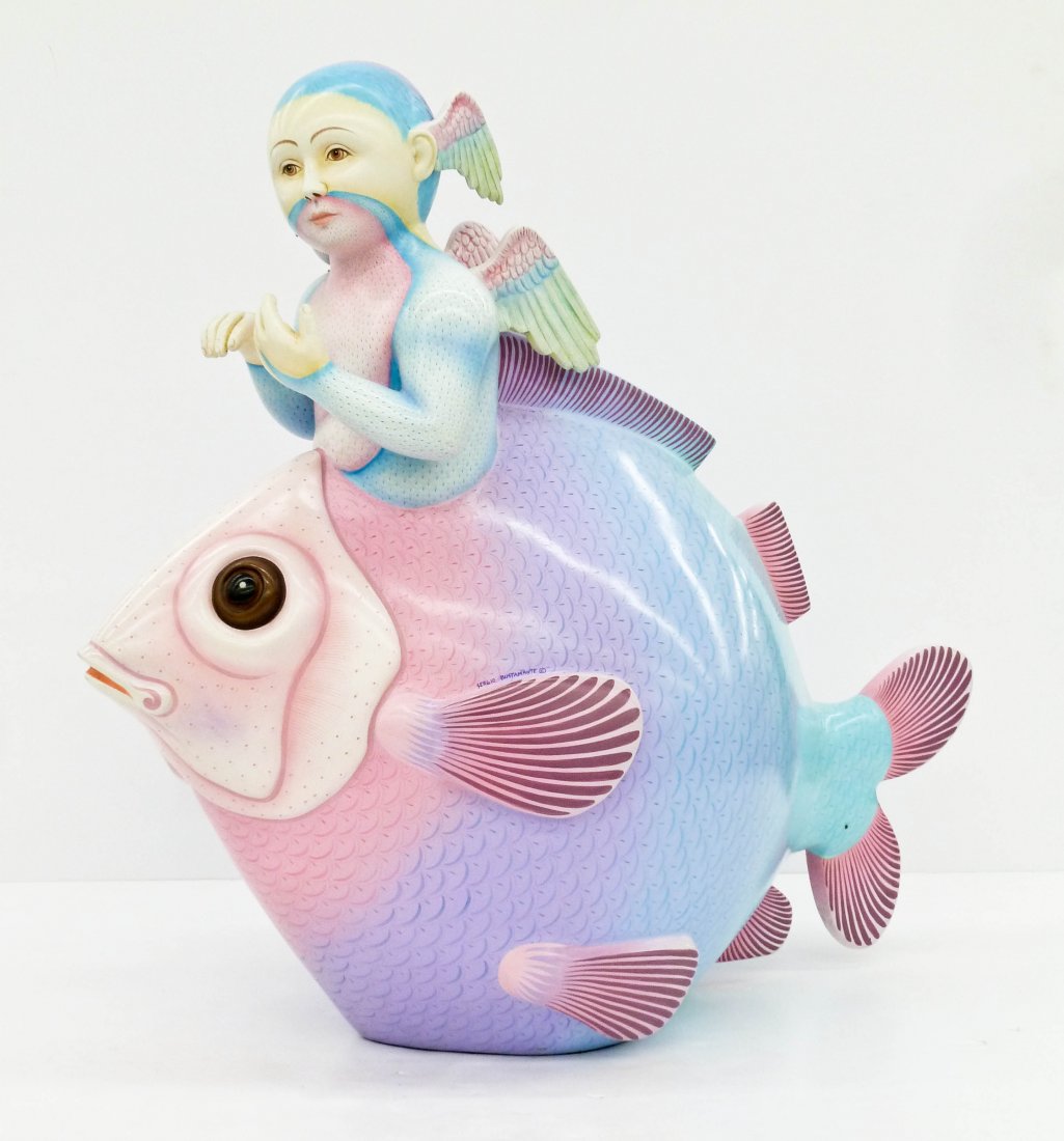 Sergio Bustamante (b.1942 Mexican) ''Large Fish with: Sergio Bustamante (b.1942 Mexican) ''Large Fish with Winged Boy'' 1994 Ceramic Sculpture 28.5''x30''. A color ceramic fantasy sculpture by this famed hispanic artist. Signed on side and comes with cer