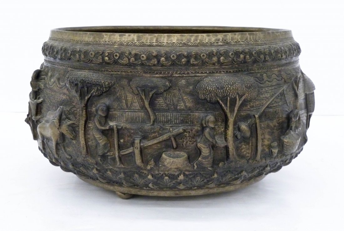 Antique Burmese Large Repousse Silver Bowl 6.5''x12''.: Antique Burmese Large Repousse Silver Bowl 6.5''x12''. Heavy relief repousse with various figures and animals in village. Bottom has stylized fish in center medallion with tripod ball feet. It tests a