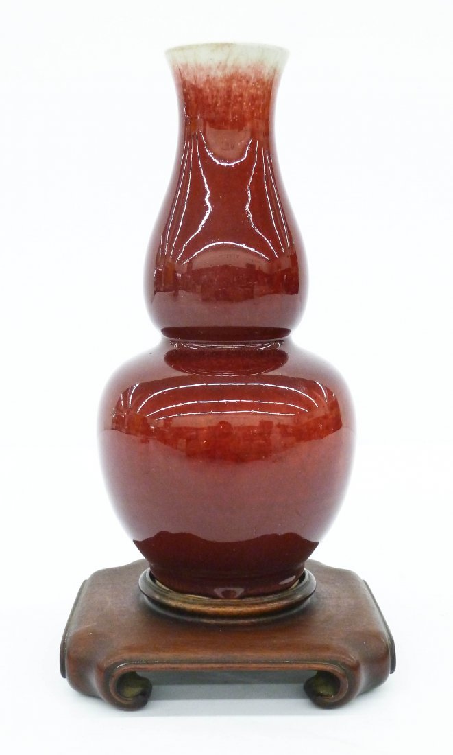 Antique Chinese Langyao Double Gourd Shaped Porcelain: Antique Chinese Langyao Double Gourd Shaped Porcelain Vase 9.5''x4.75''. Stark red oxblood (sang de boeuf) glaze that dissipated towards mouth. It comes on ornate fitted carved rosewood stand. Drilled