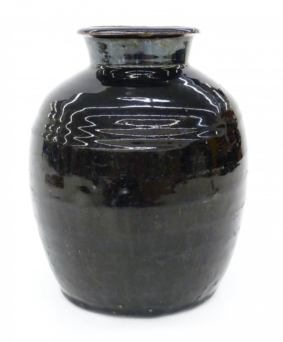 Chinese Ming Henan Black Stoneware Storage Jar: Chinese Ming Henan Black Stoneware Storage Jar 9.5''x8''. Covered in a stark black mirror like glaze. Kiln chips to bottom that are original to its manufacture. Small chip to top edge, otherwise excel