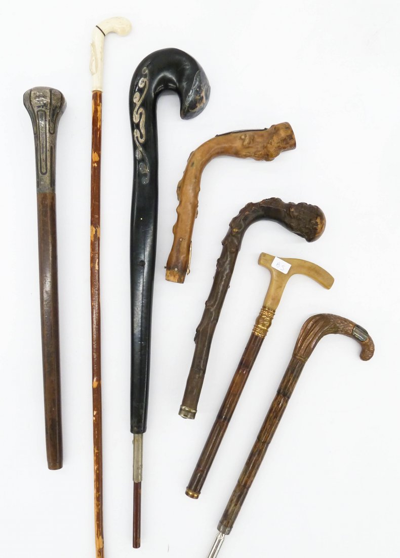 Collection of Antique Walking Stick Handles. Group: Collection of Antique Walking Stick Handles. Group includes eight cane and walking stick handles made of carved wood, bone, horn, hammered copper, and sterling silver. Sizes range from 5.5'' to 27'' l