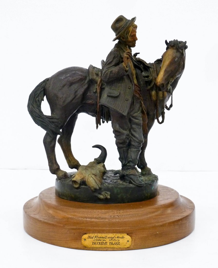 Buckeye Blake (b.1946 Montana) ''Kid Russell and Monte: Buckeye Blake (b.1946 Montana) ''Kid Russell and Monte Circa 1889'' 1986 Western Bronze Sculpture 12.5''x10.5''. A patined bronze sculpture of the artist C.M. Russell with his typical cow skull at bas