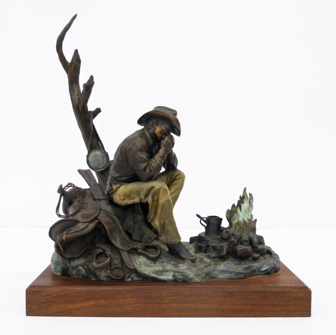 Terry Murphy (20th Cent. Montana) ''Campfire Dreams'': Terry Murphy (20th Cent. Montana) ''Campfire Dreams'' 1997 Bronze Sculpture 18.5''x17''. A charming patinated bronze sculputre depicting a cowboy next to a camp fire. Signed and numbered 18 of 24 edit