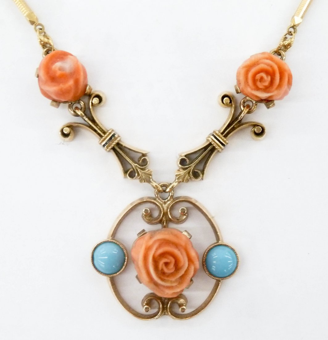 Lady's 18k Carved Coral & Turquoise Pendant Necklace: Lady's 18k Carved Coral & Turquoise Pendant Necklace 18''. It has three carved pink coral roses with two turquoise cabochons. Pendant measures .75''. Marked ''750 K18'' on clasp. It weighs 17.6 grams 
