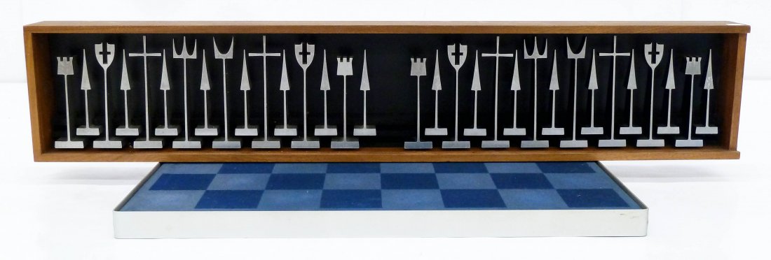 Austin Cox ''Alcoa'' Modernist Chess Set. Designed in: Austin Cox ''Alcoa'' Modernist Chess Set. Designed in 1962 with solid aluminum pieces. Complete set with fitted walnut box 6''x30.5''. Austin Enterprises, Akron Ohio label on verso. Original felt ches