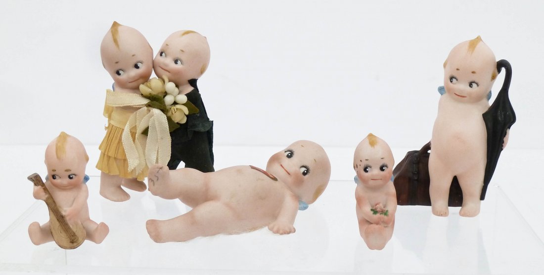 5pc Kewpie German Bisque Action Figures. Includes a: 5pc Kewpie German Bisque Action Figures. Includes a wedding couple 3.75'', a traveler with bag and umbrella 3.5'', a reclining Kewpie with paper label 4.5'', and two figural place card holders 2'' eac